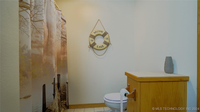 bathroom with tile patterned flooring and toilet