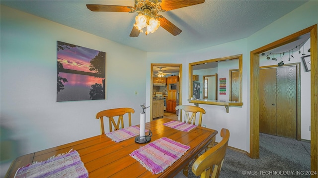 dining area with carpet flooring and a textured ceiling