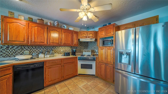 kitchen with ceiling fan, light tile patterned floors, a textured ceiling, tasteful backsplash, and stainless steel appliances