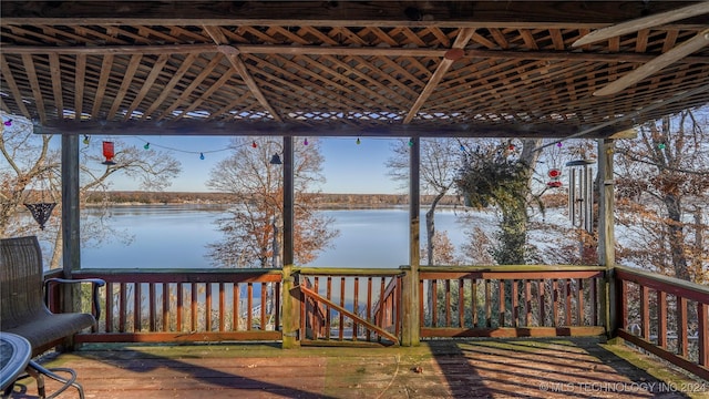 wooden terrace featuring a water view