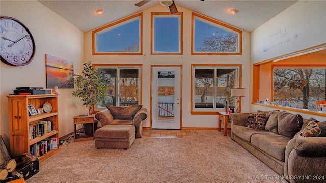 living room with beam ceiling, ceiling fan, carpet floors, and high vaulted ceiling