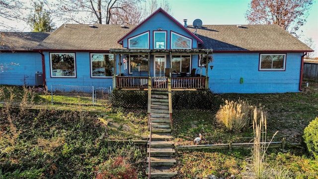 rear view of house with a porch and central air condition unit