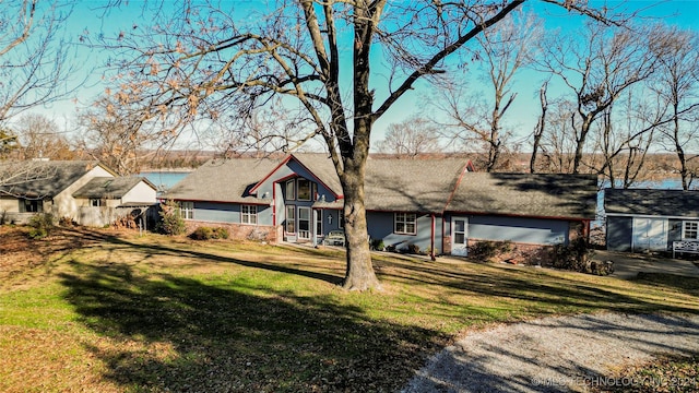 ranch-style home featuring a front yard