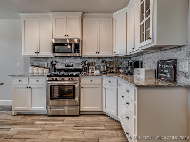 kitchen with white cabinetry and stainless steel appliances