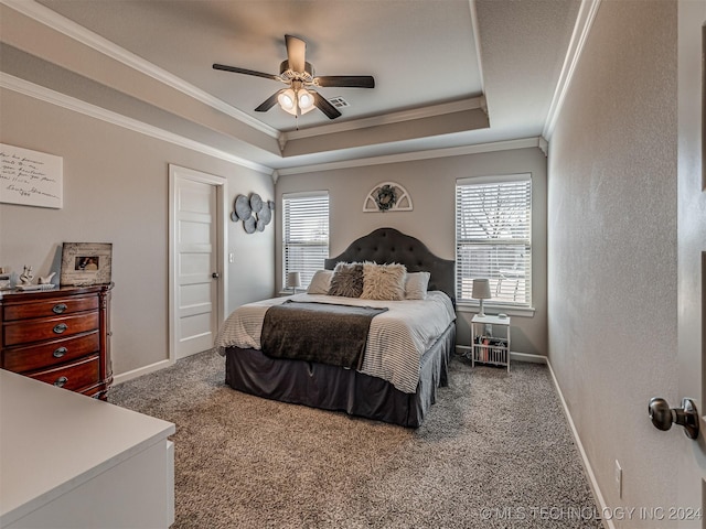 carpeted bedroom featuring a raised ceiling, ceiling fan, and ornamental molding