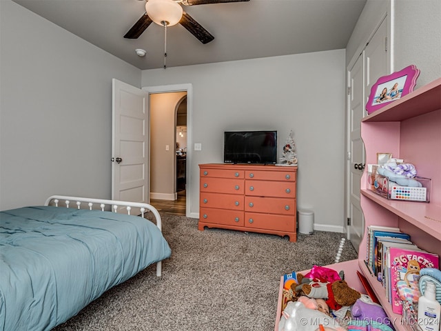 bedroom featuring ceiling fan and dark colored carpet