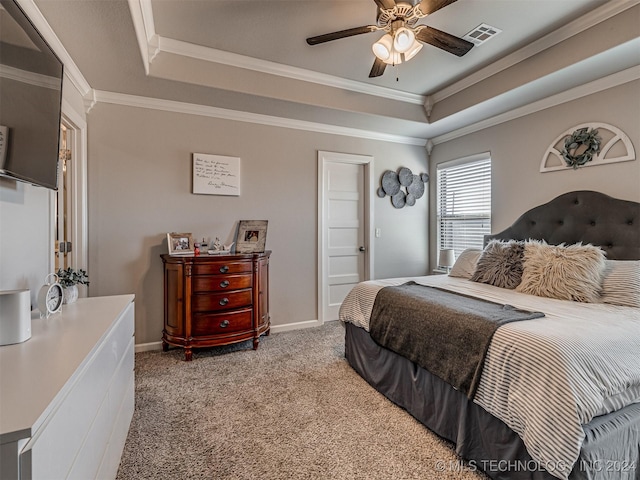 bedroom with a tray ceiling, ceiling fan, light colored carpet, and ornamental molding