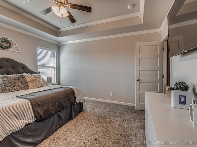 carpeted bedroom featuring ceiling fan, a raised ceiling, and crown molding