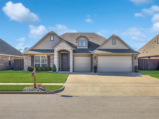 view of front of property featuring a front yard and a garage