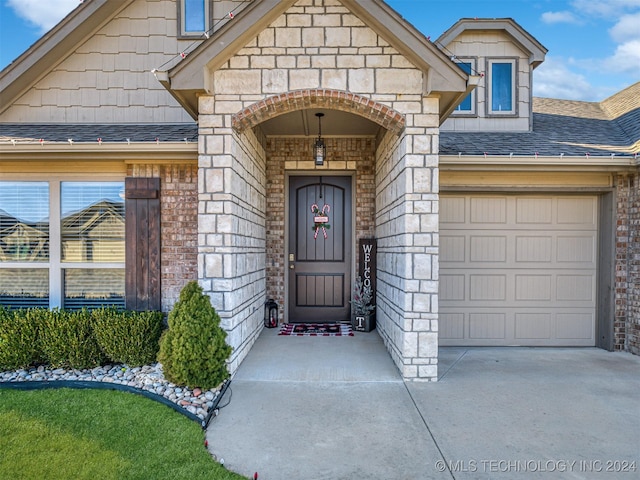 doorway to property with a garage