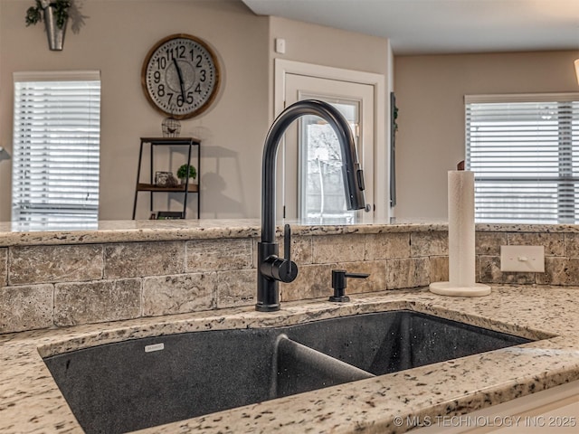 room details featuring decorative backsplash and sink