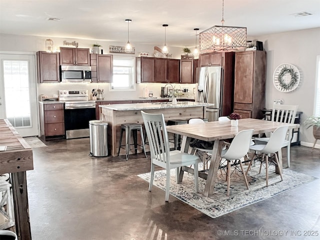 dining area featuring a notable chandelier and sink