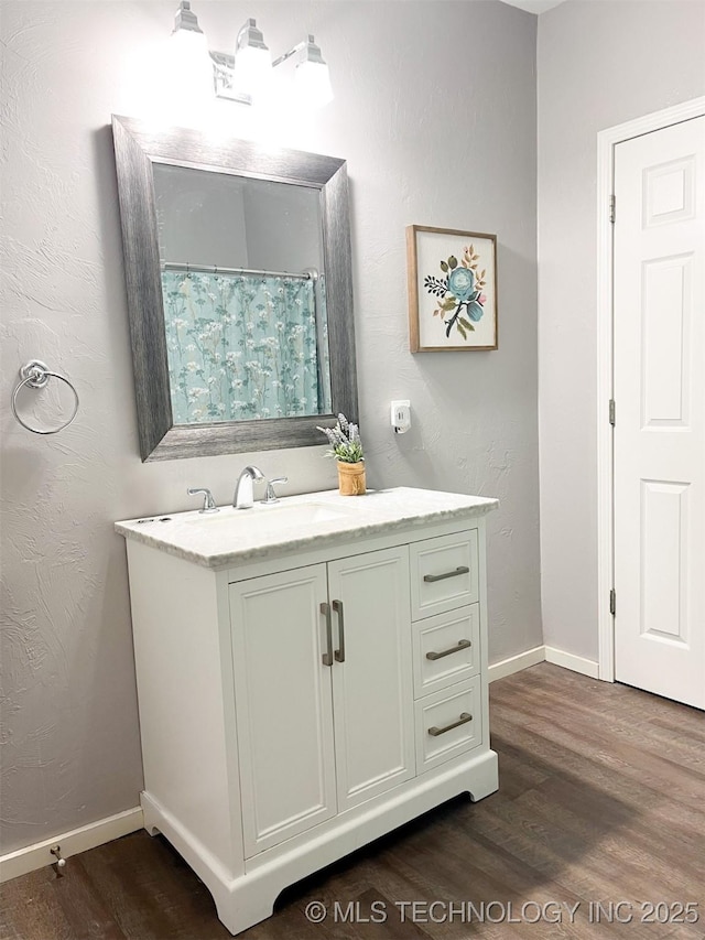 bathroom with hardwood / wood-style floors and vanity