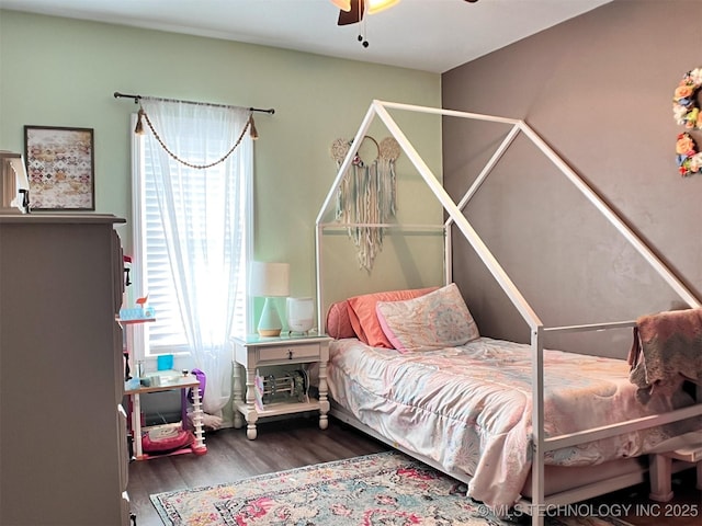 bedroom featuring ceiling fan and dark wood-type flooring