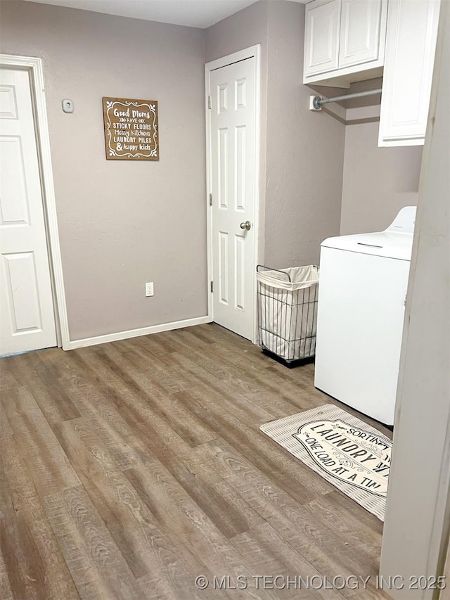 laundry room featuring washer / clothes dryer, light hardwood / wood-style floors, and cabinets