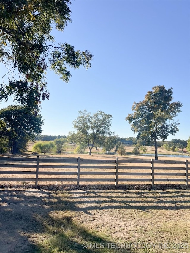 view of gate with a rural view