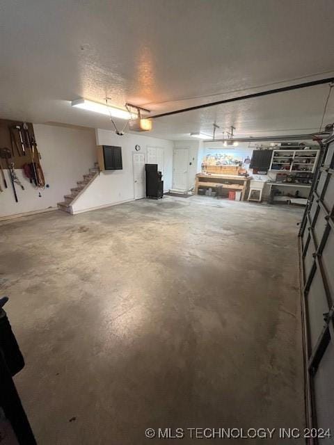 garage featuring a workshop area and a garage door opener