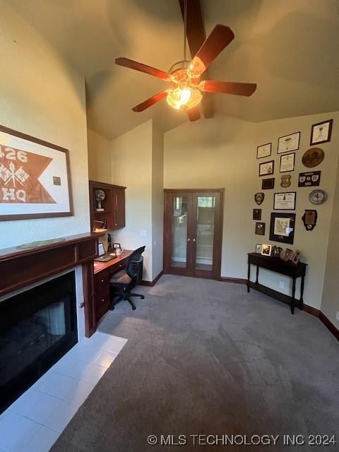 carpeted office space featuring ceiling fan, french doors, and high vaulted ceiling