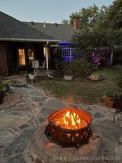 exterior space with a patio and an outdoor fire pit