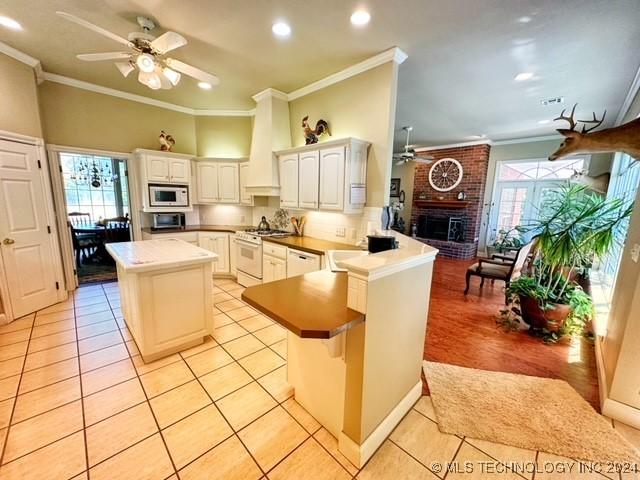 kitchen with kitchen peninsula, a center island, and a healthy amount of sunlight