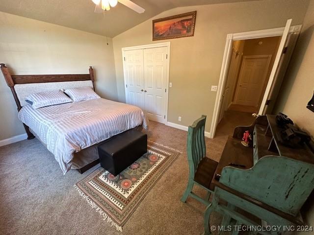 bedroom featuring carpet, ceiling fan, a closet, and vaulted ceiling