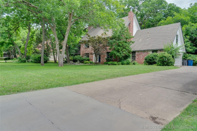 view of front of house with a front yard and a garage