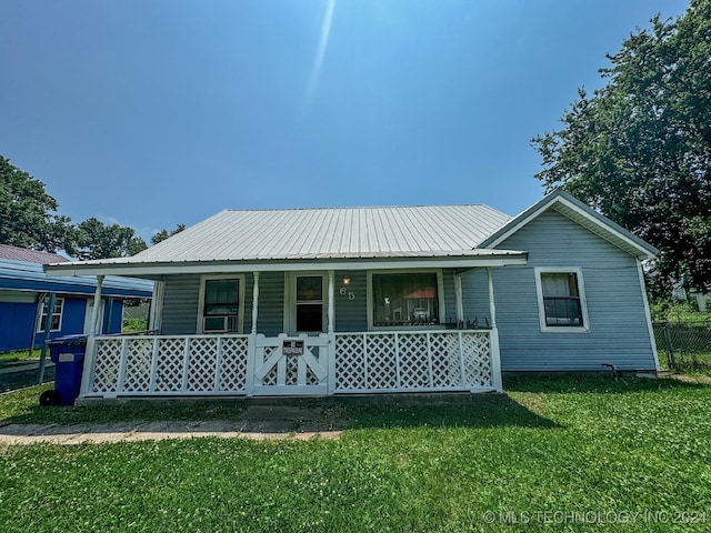 view of front of home with a front yard and a porch