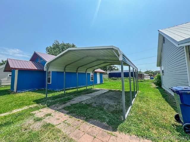 view of vehicle parking with a lawn and a carport