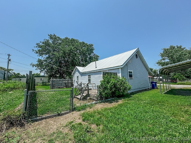 view of home's exterior featuring a carport and a yard