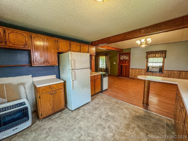 kitchen featuring an inviting chandelier, light wood-type flooring, a textured ceiling, white fridge, and heating unit