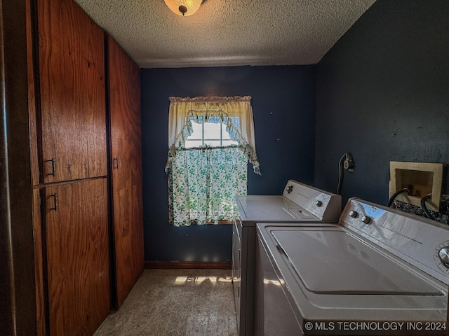 laundry area featuring washer and dryer, a textured ceiling, carpet flooring, and cabinets