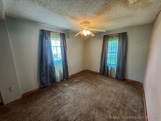 unfurnished room with ceiling fan, carpet floors, and a textured ceiling