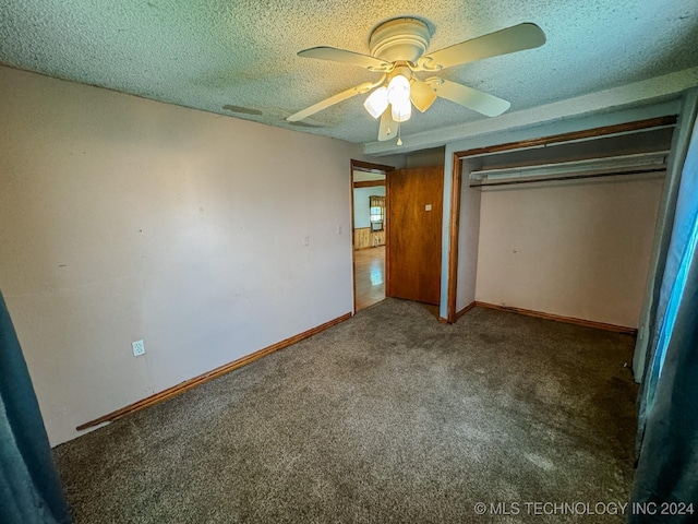 unfurnished bedroom with a textured ceiling, carpet floors, a closet, and ceiling fan