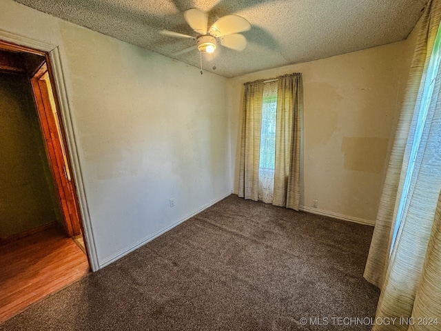 unfurnished bedroom with carpet, ceiling fan, and a textured ceiling