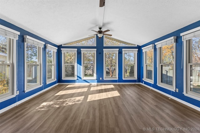 unfurnished sunroom with vaulted ceiling with beams, ceiling fan, and a healthy amount of sunlight