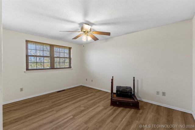 empty room featuring wood-type flooring and ceiling fan