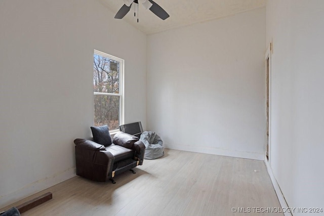 sitting room with vaulted ceiling, light hardwood / wood-style flooring, and ceiling fan