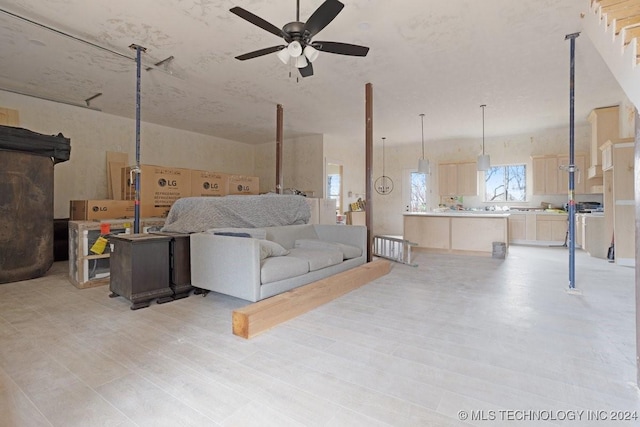 living room featuring ceiling fan and light hardwood / wood-style flooring