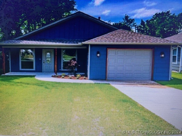 view of front of property with a front lawn and a garage