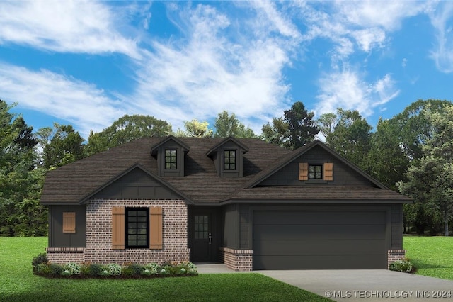 view of front of home featuring a garage and a front lawn