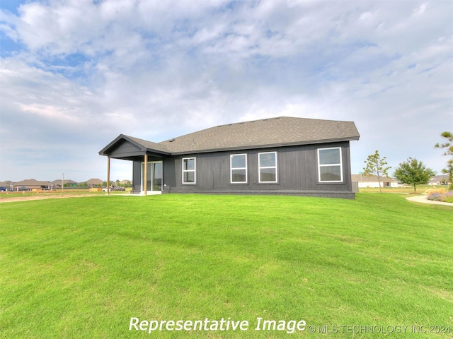 rear view of property with a lawn