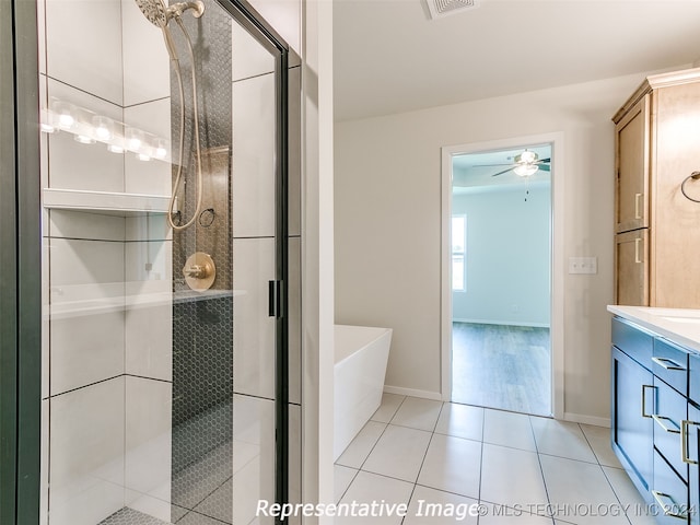 bathroom featuring tile patterned floors, ceiling fan, vanity, and shower with separate bathtub