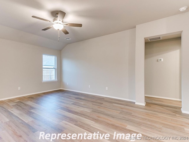 spare room featuring light hardwood / wood-style flooring, ceiling fan, and lofted ceiling