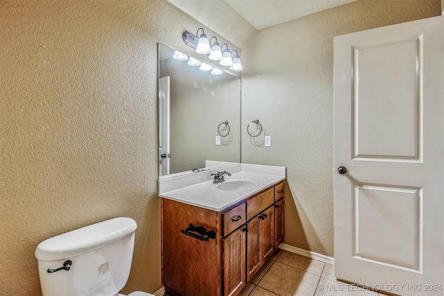 bathroom featuring toilet, vanity, and tile patterned floors