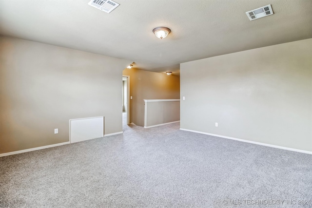 empty room featuring a textured ceiling and carpet floors