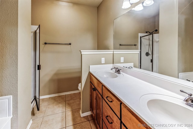 bathroom with tile patterned floors, vanity, toilet, and an enclosed shower