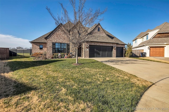 view of front of home with a front yard and a garage