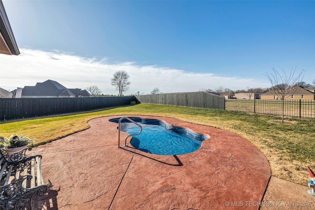 view of swimming pool featuring a lawn and a patio area