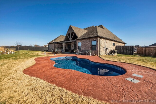 view of swimming pool with a lawn and a patio area