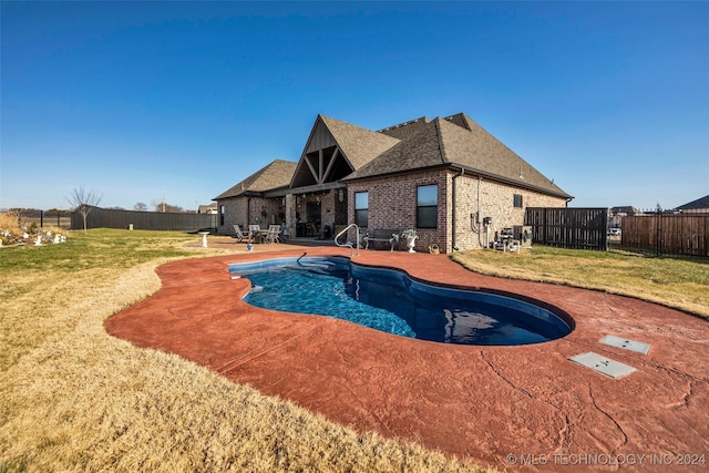 view of swimming pool with a yard and a patio